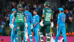 India's Kuldeep Yadav celebrates the wicket of Pakistan's Agha Salman with teammates